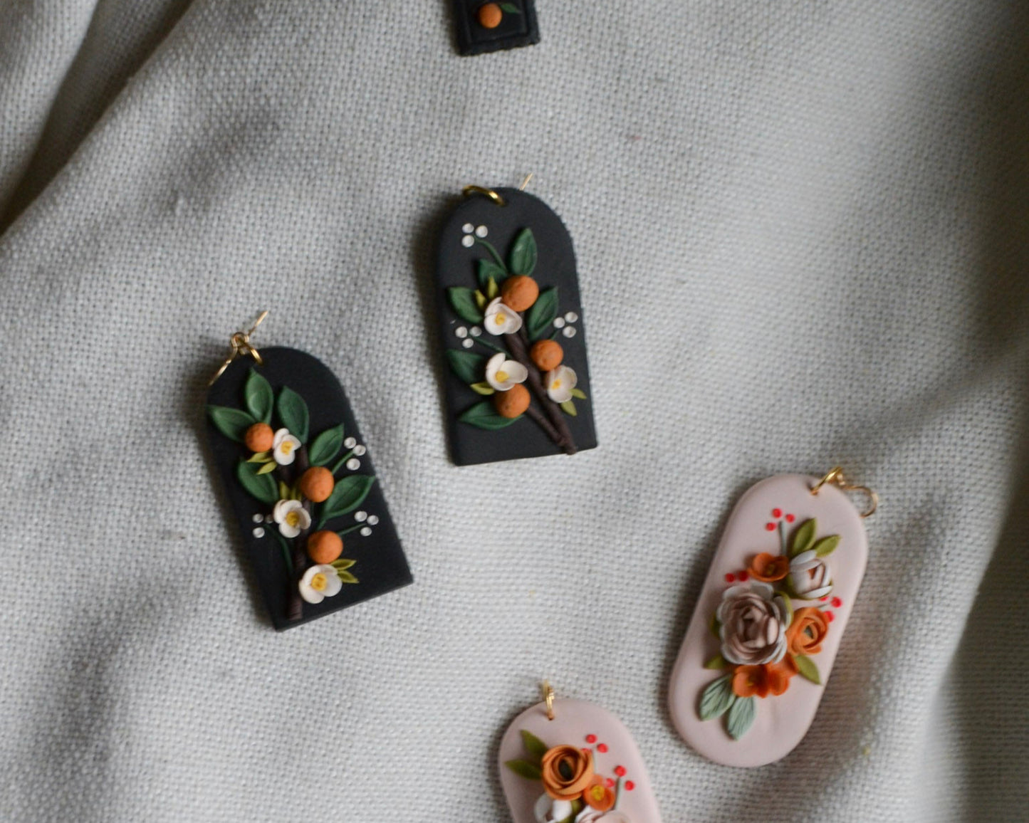 Floral earrings on a textured fabric background
