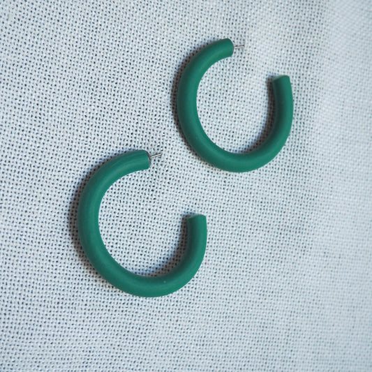 Medium emerald green hoops on white textured background