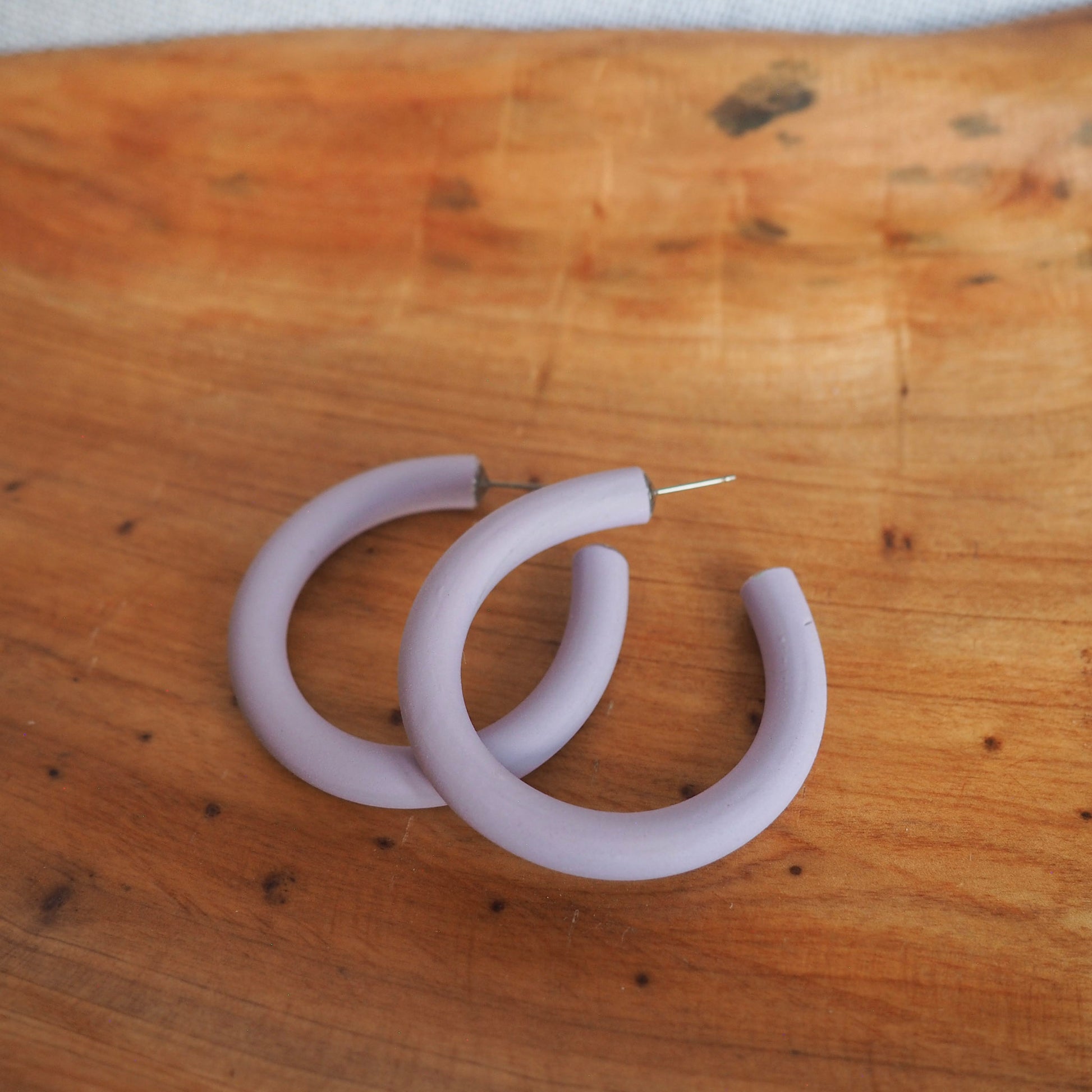Medium lavender hoops on wood background